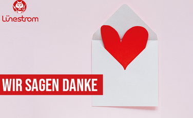 Rotes Herz im weißen Briefumschlag mit Schriftzug "Wir sagen Danke"